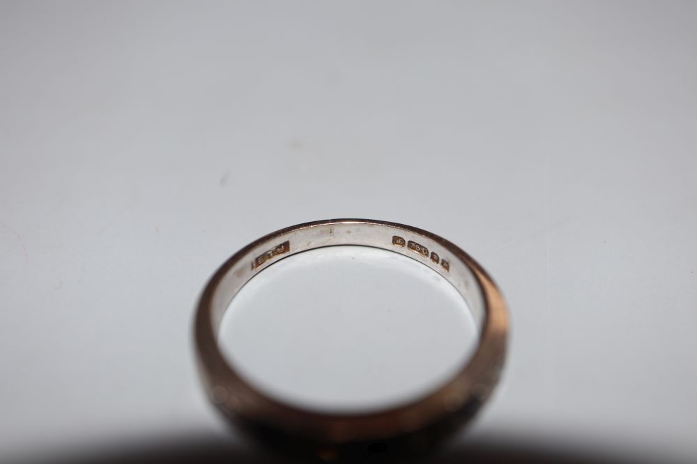 A modern 18ct white gold, sapphire and diamond set seven stone half hoop ring, size N, gross 3.7 grams.